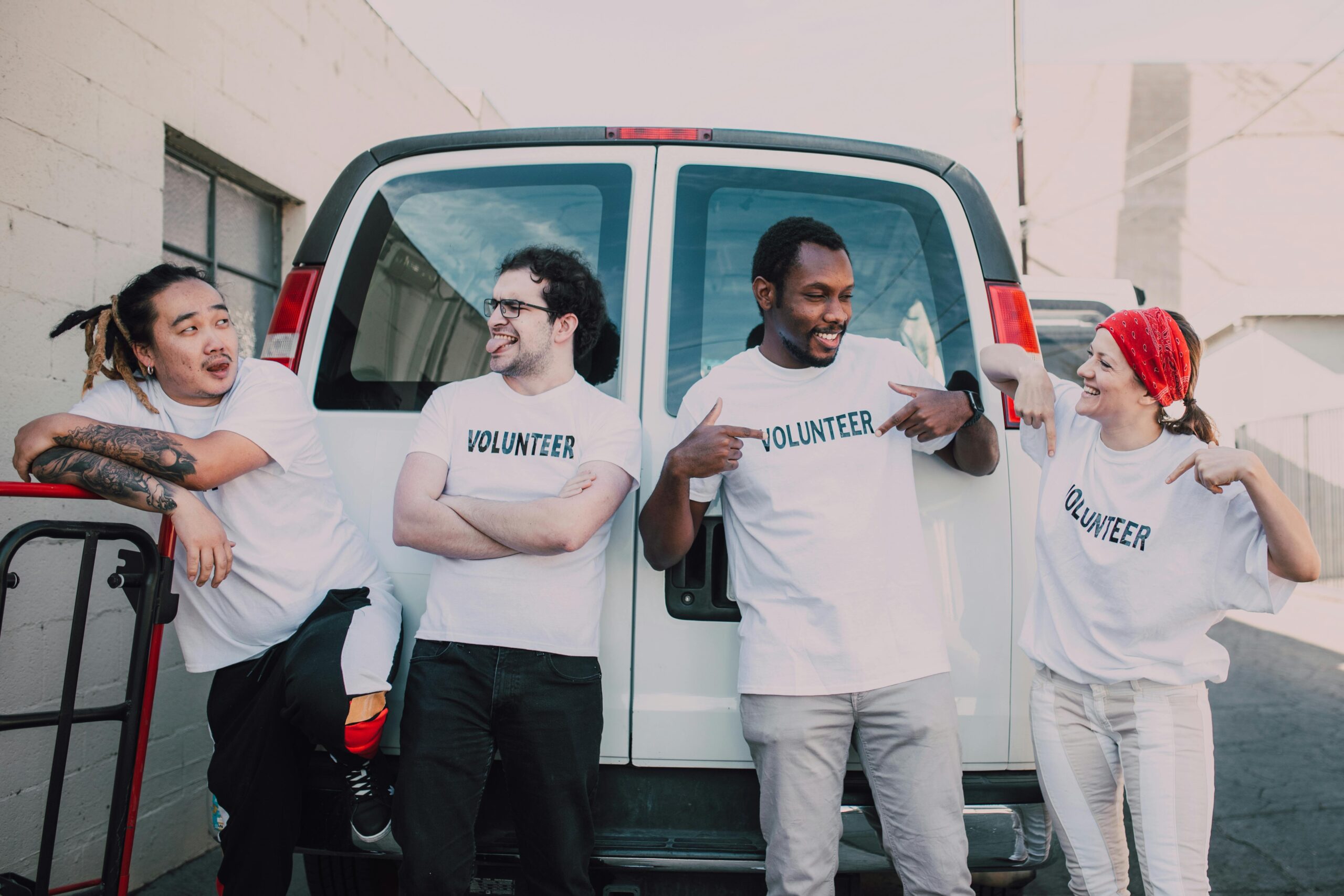 Group of Charity volunteers by a van ready to take donations