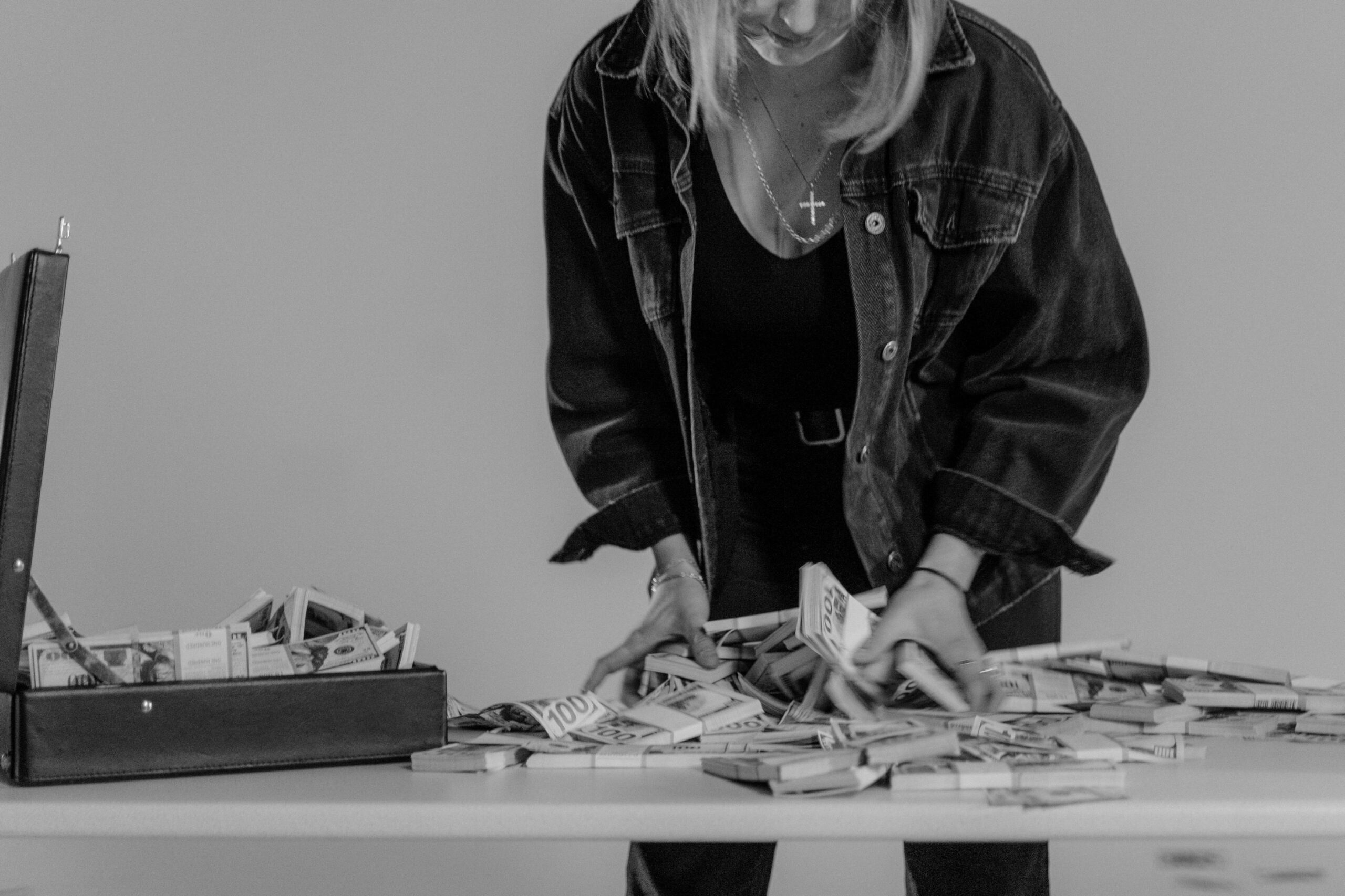 Charity volunteer lady counting cash donations on a table