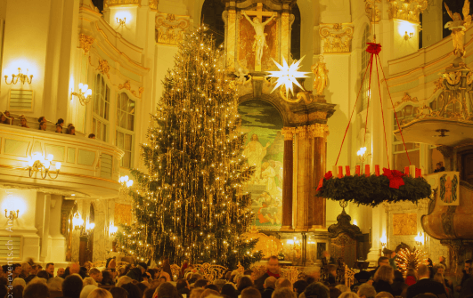 Christmas fundraising image with lots of lights and candles around the tree