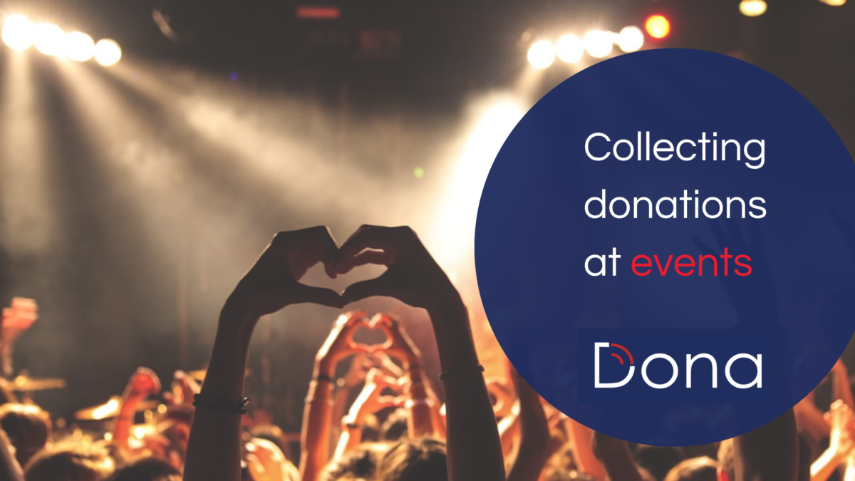 People at a fundraising concert making the heart sign