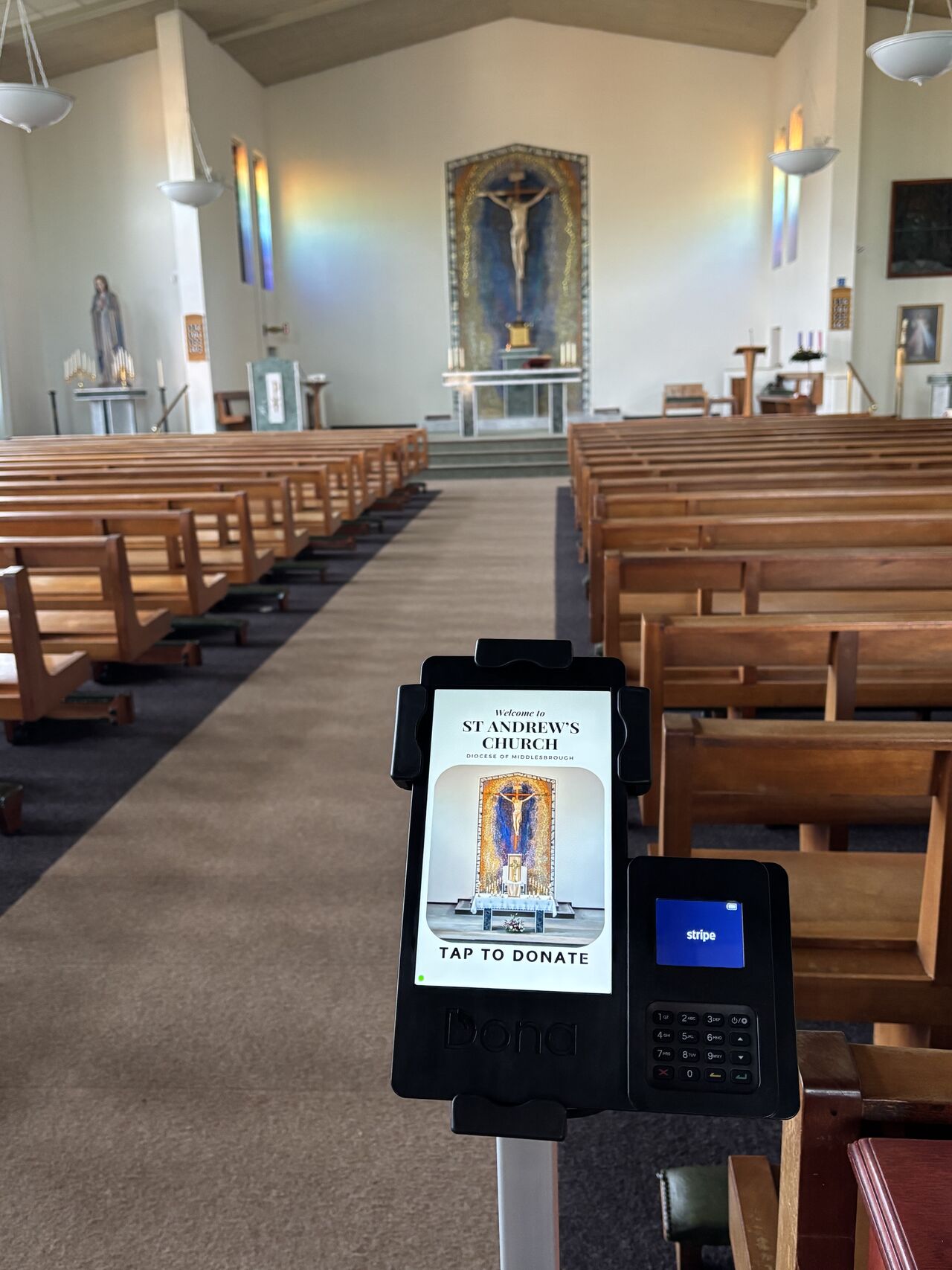 Great view of the central aisle with a donation machine ready to accept payments
