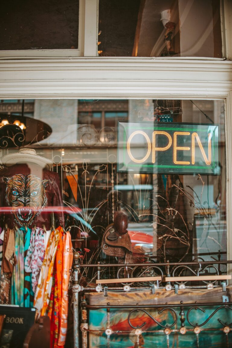 Shop window of a charity shop with open sign in green border
