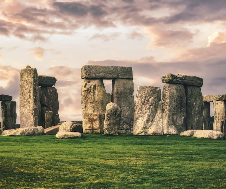 Stonehenge in front of a moody sky and green grass