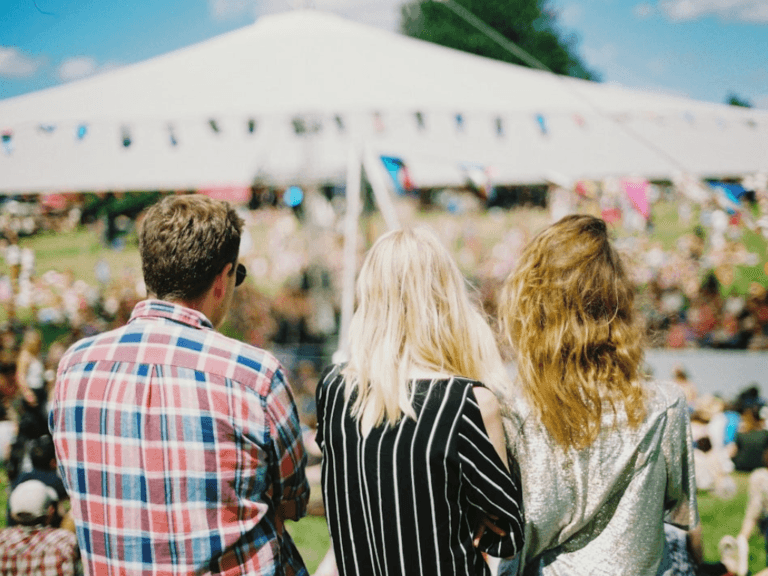 People at an event where mobile donations are taken with tent in background