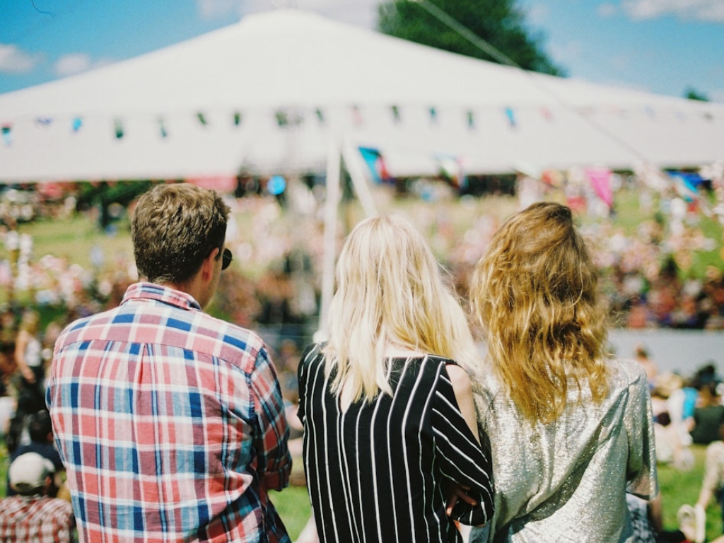People at an event where mobile donations are taken with tent in background