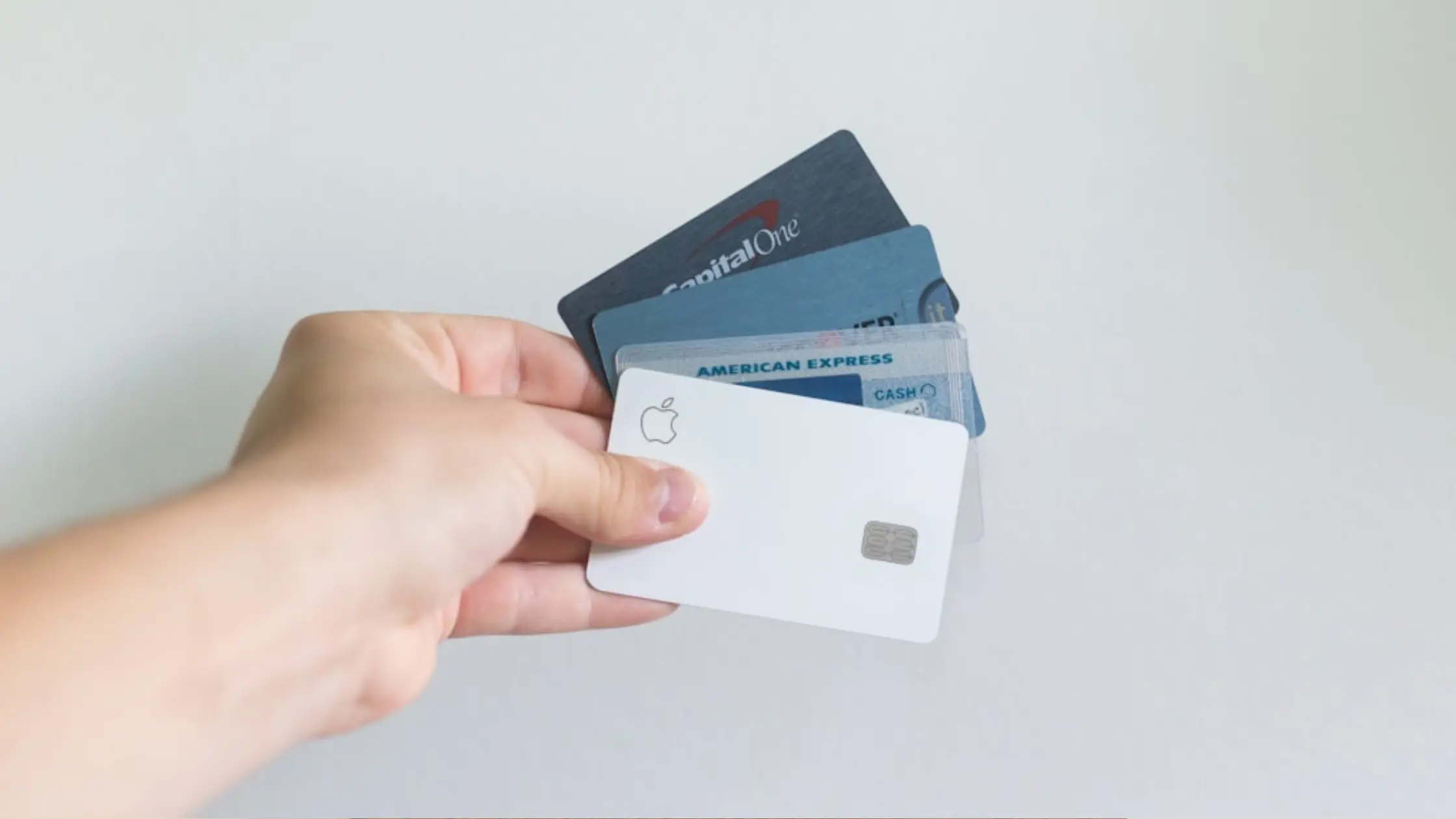 Selection of credit cards held by a person ready to make a secure donation