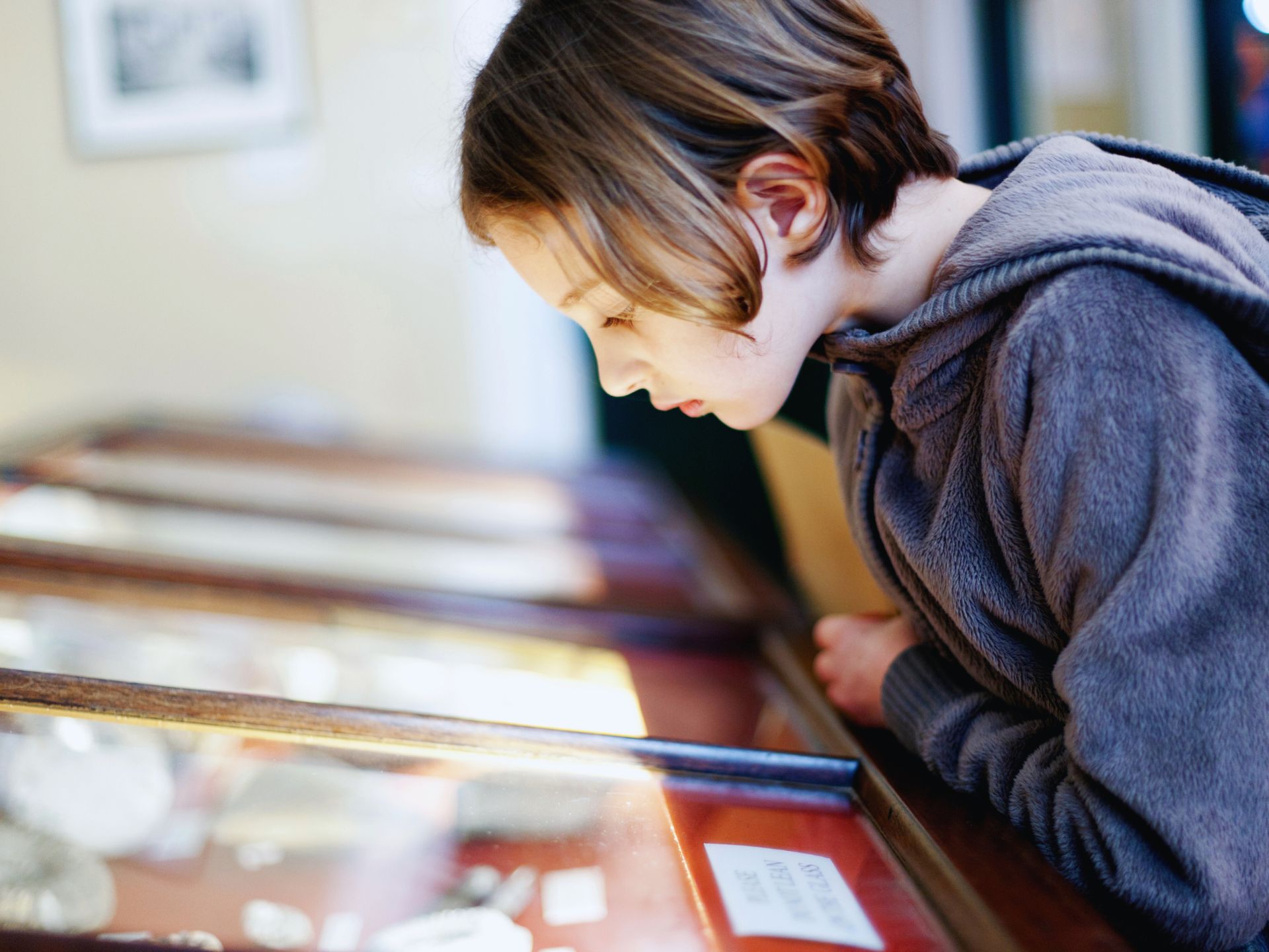 Child on summer holidays looking at an exhibit at a museum