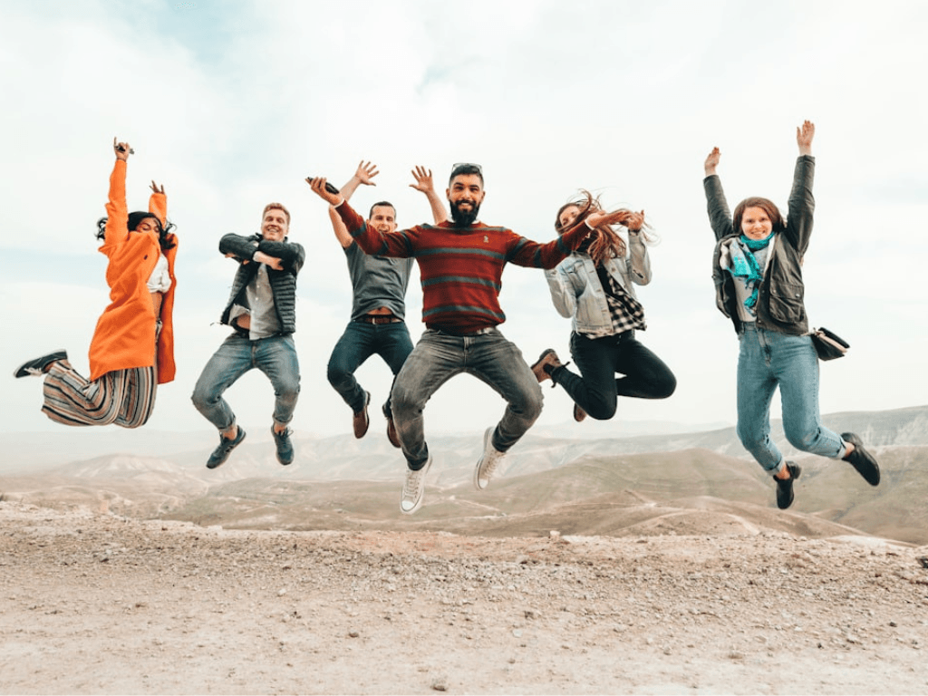 Corporate team jumping for joy after team fundraising event