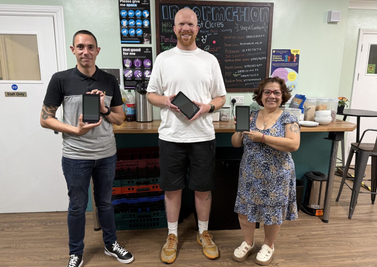 donated tablets being presented to the charity from dona to turning tides